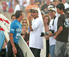 Surfer Cory Lopez is surrounded by well-wishers as his dad, Pete, of Indian Rocks Beach, phones the great news on his son’s victory.